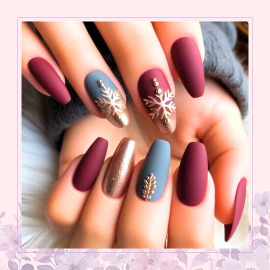 Burgundy and grey nail design with gold snowflakes