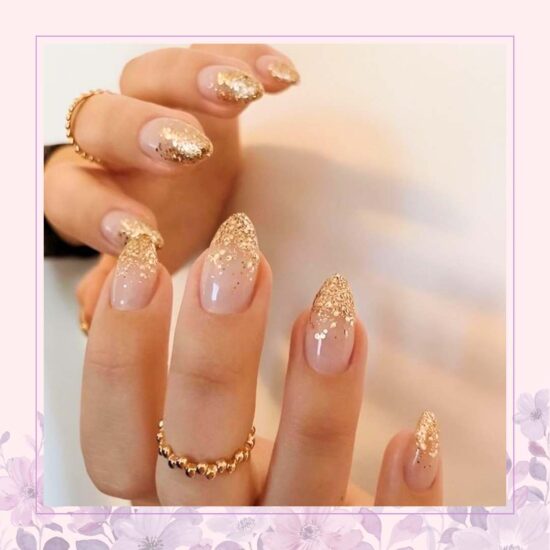 Nude with cascading gold glitter nail art design