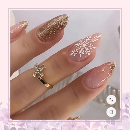 Nude with rose gold glitter and snowflake nail design